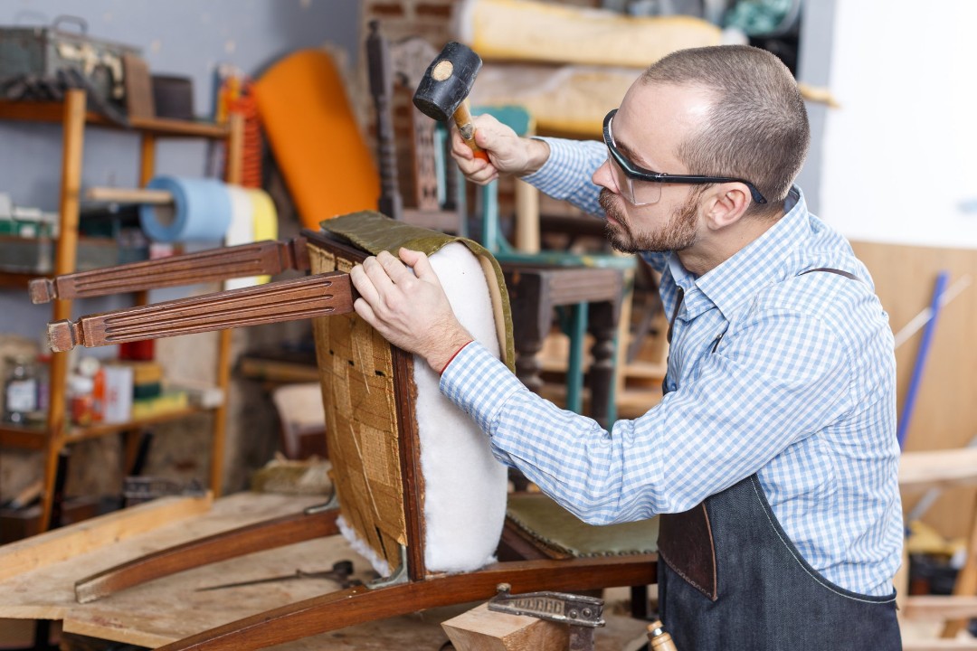 Craftsman building an upholstered chair.