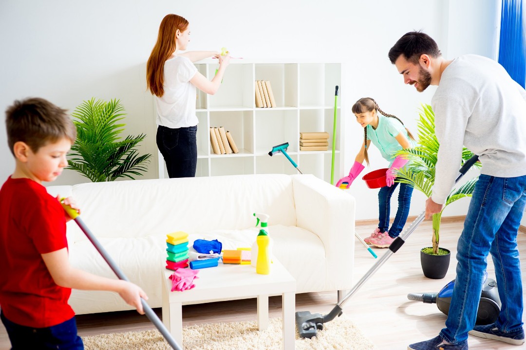 Family working together to clean the furniture and carpets.