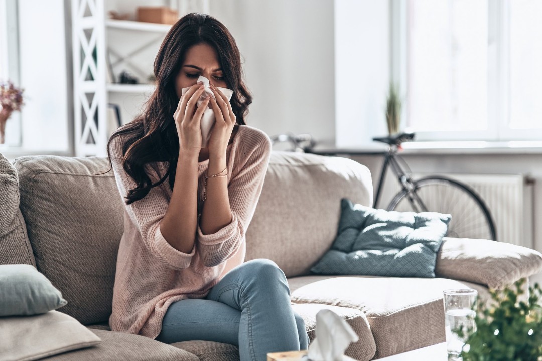 Woman with allergy symptoms from poor air quality