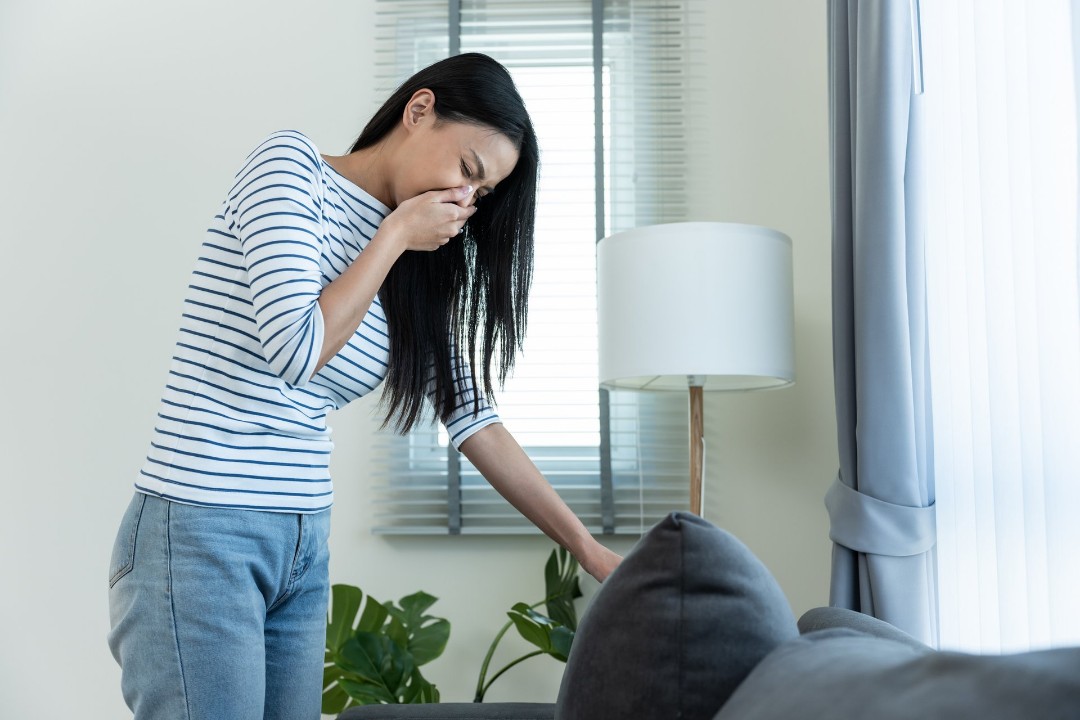 Woman smelling poor indoor air