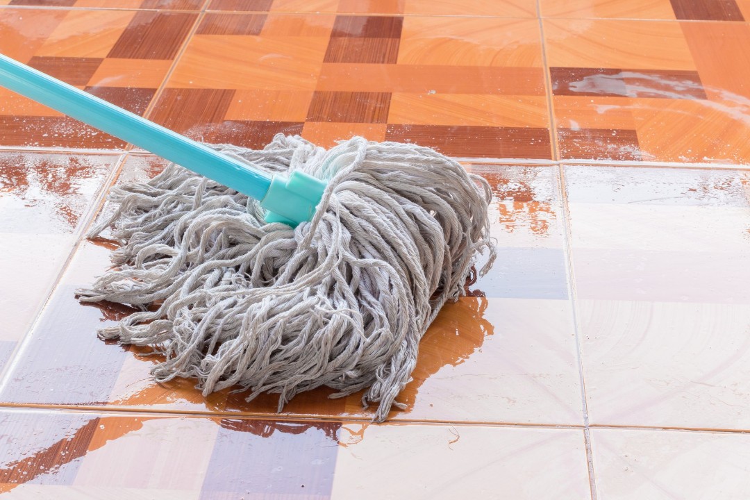 Wet mop cleaning tile floor
