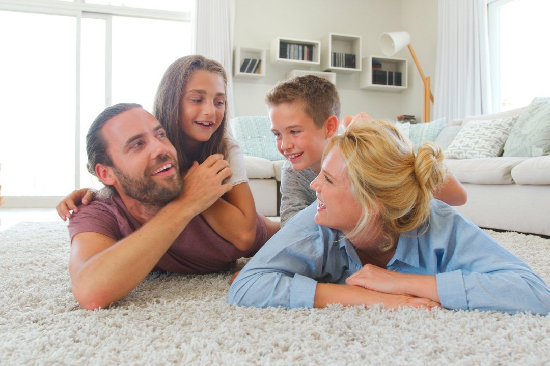 Family happy after professional carpet cleaning in Minnesota summer