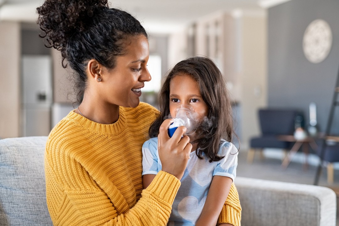 Child using nebulizer at home