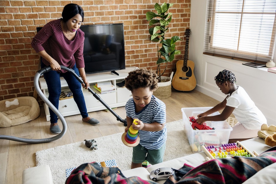 Family cleaning the living room before back-to-school season