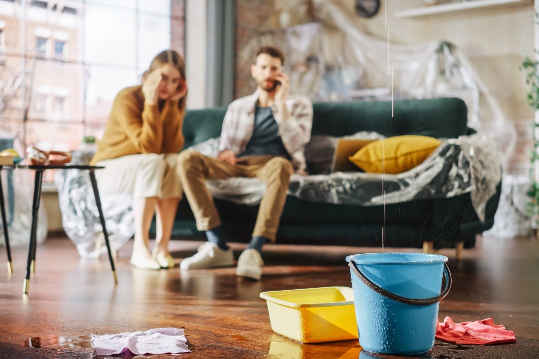 Couple with a water leak in their living room