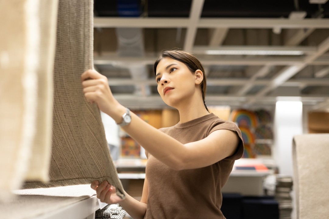 Woman analyzing carpet quality and warranty