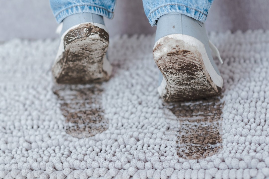 Dirty footprints on carpet that needs professional cleaning